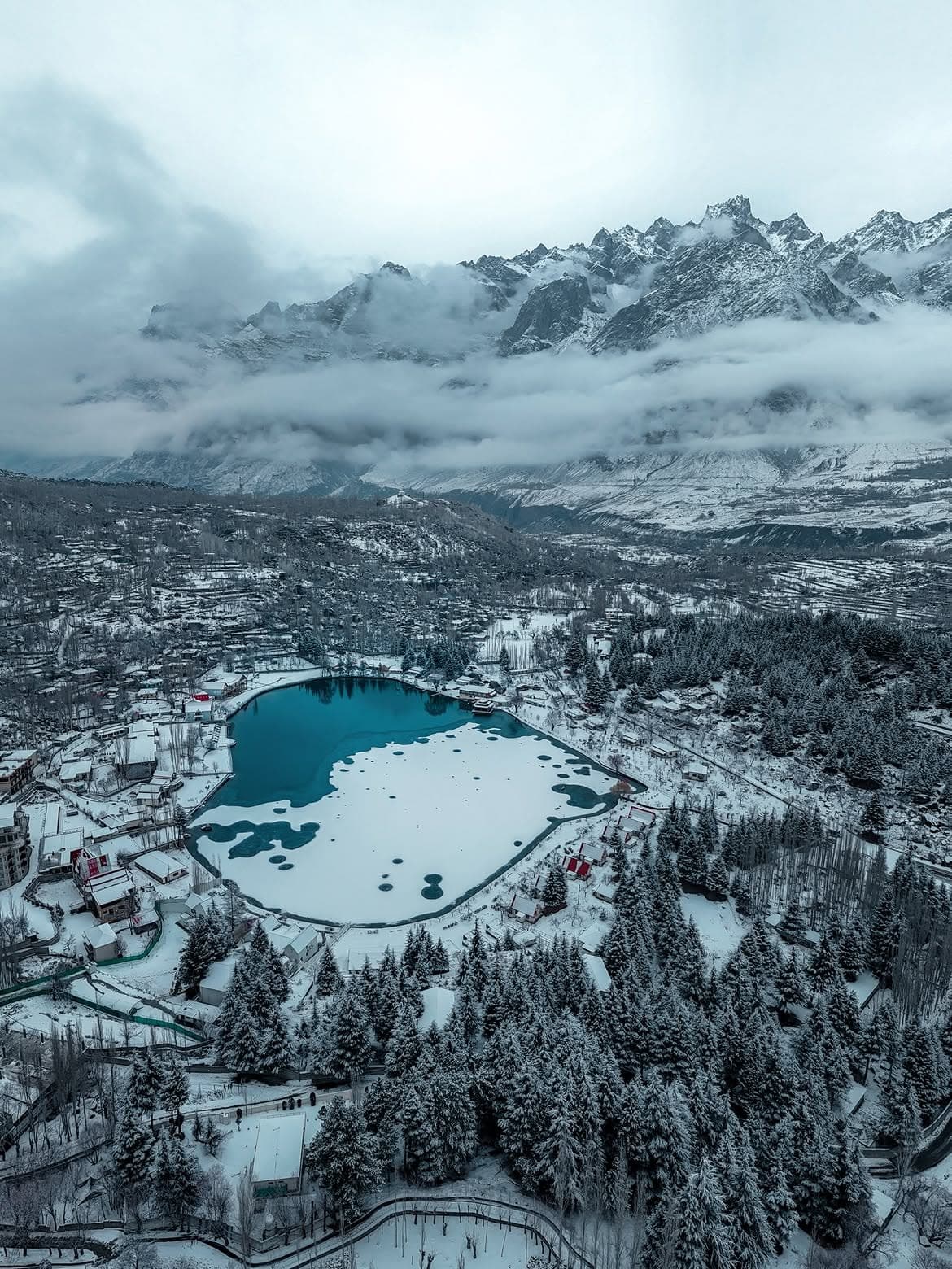Snow-covered village and frozen lake in Gilgit-Baltistan winter